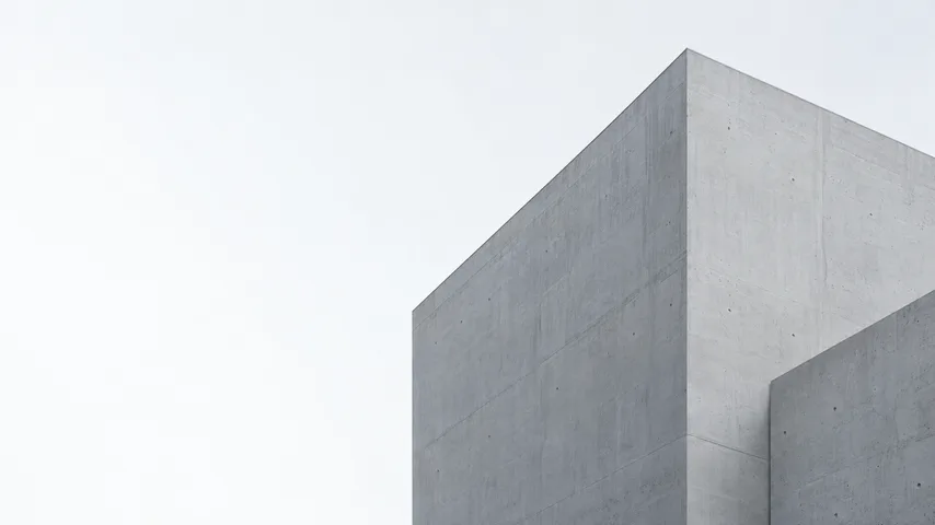 Minimal concrete architecture against a pale sky.
