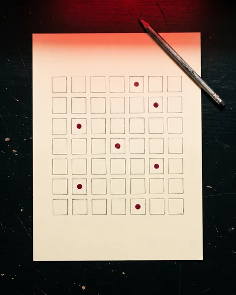 A month of posts planned on paper — a hand-drawn grid with red dots.